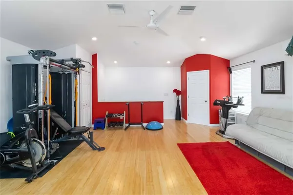 a living room with furniture gym equipment and a mirror