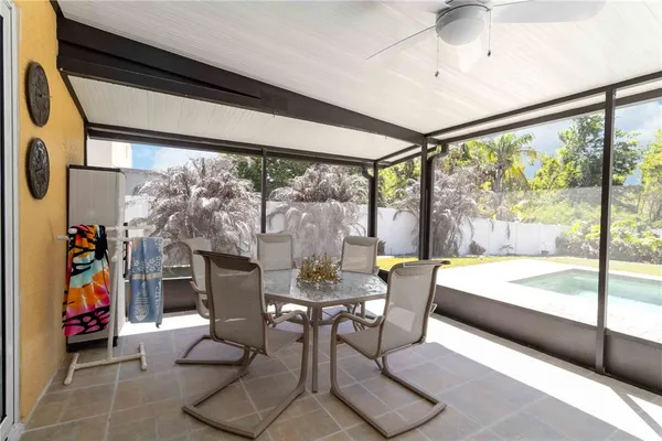 a dining room with furniture water view and large windows