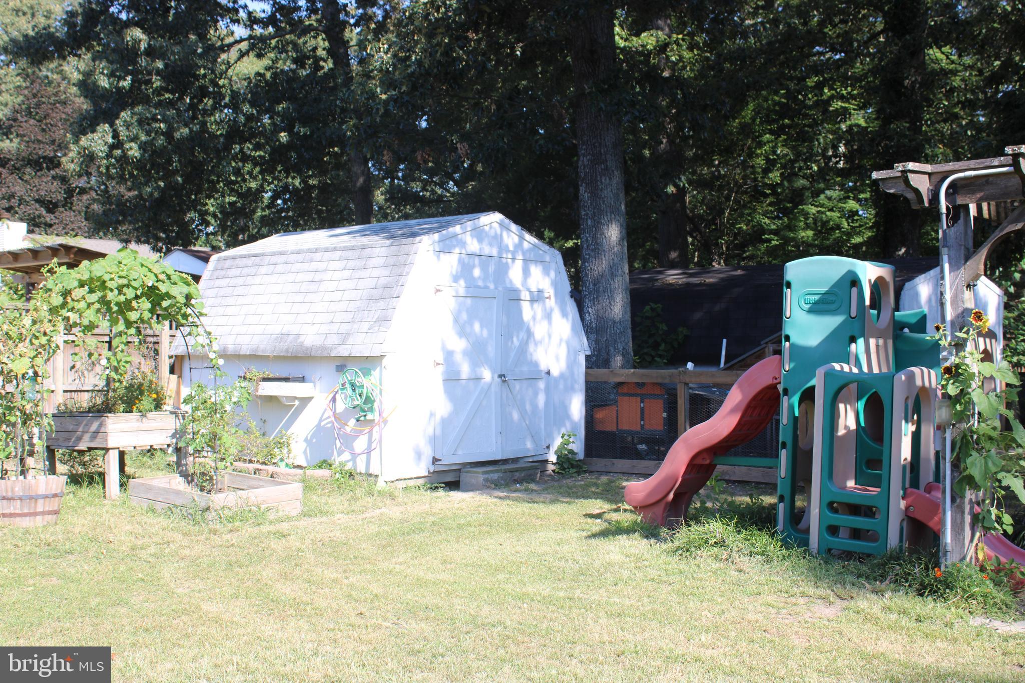 32 Nicholson Drive Pasadena, MD 21122 - Photo 16 of 21 a view of a backyard with a table and chairs