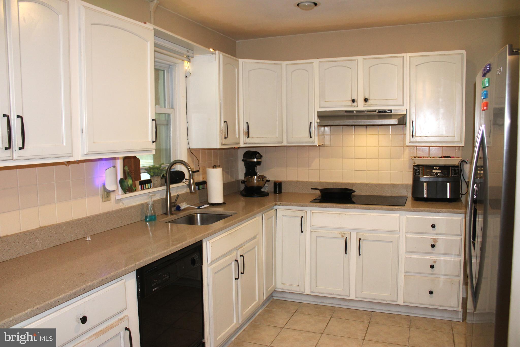 32 Nicholson Drive Pasadena, MD 21122 - Photo 3 of 21 a kitchen with cabinets appliances a sink and a counter top space