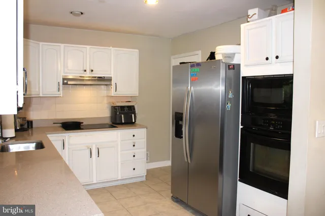 a kitchen with stainless steel appliances a refrigerator and a stove