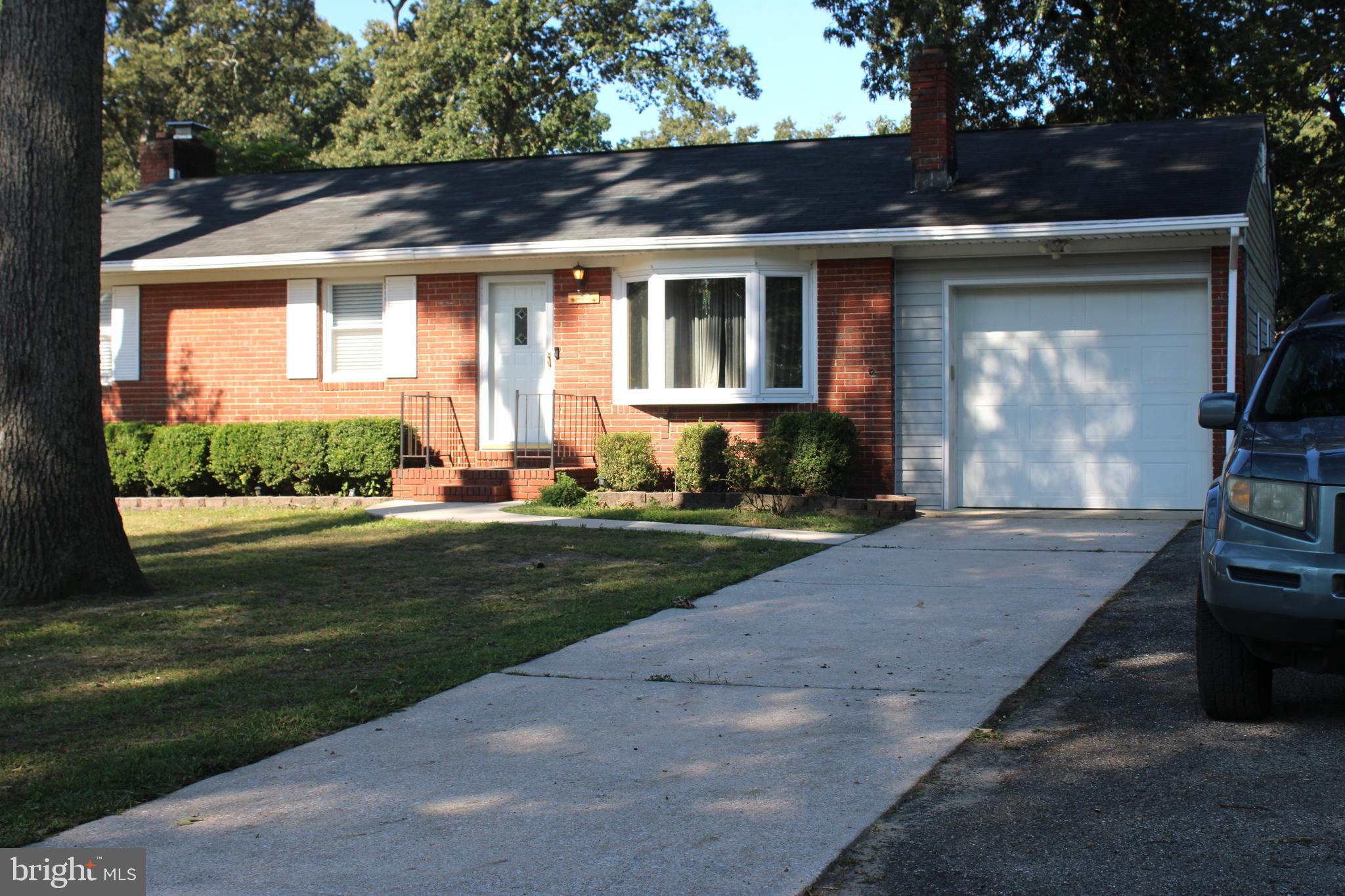 32 Nicholson Drive Pasadena, MD 21122 - Photo 7 of 21 a front view of a house with a yard table and chairs