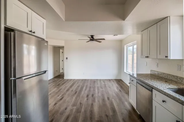 a kitchen with a refrigerator and a sink