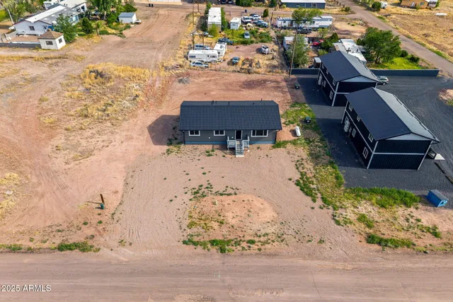 an aerial view of a house with a yard