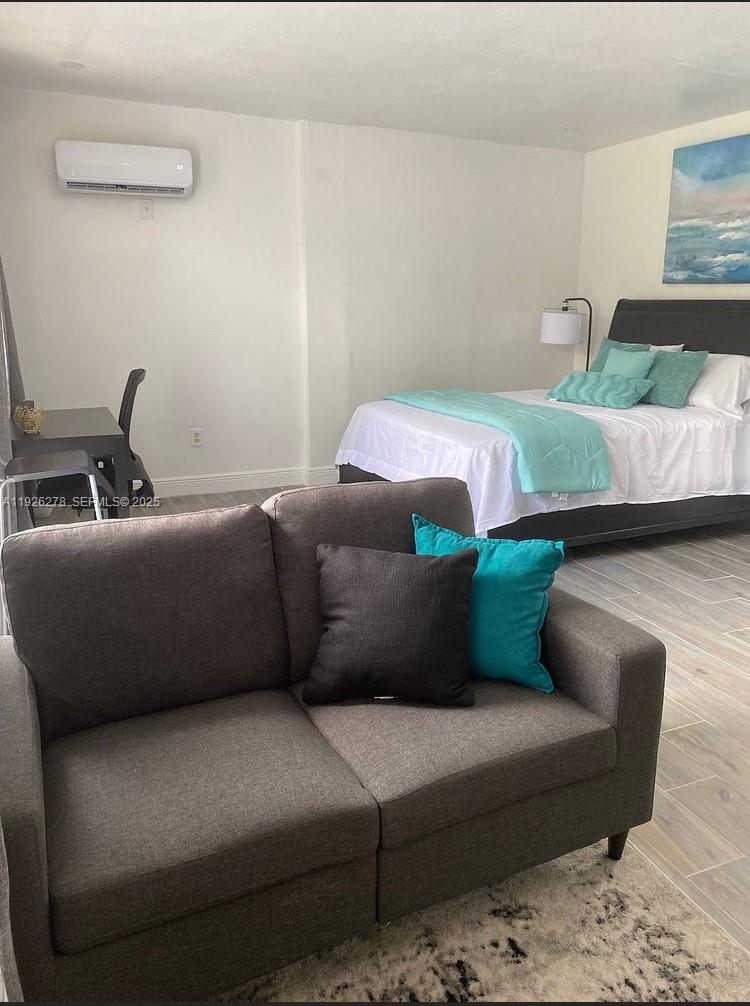 1350 Northwest 52nd Street, Unit A Miami, FL 33142 - Photo 4 of 6 a living room with furniture and a couch