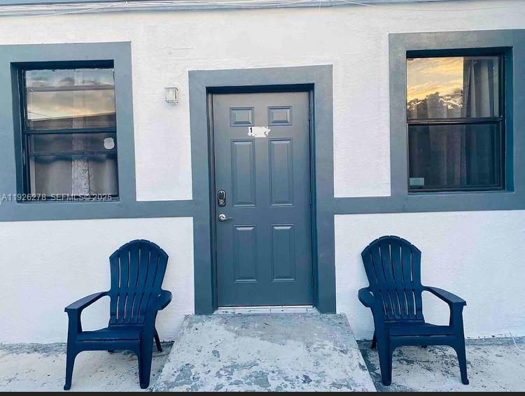1350 Northwest 52nd Street, Unit A Miami, FL 33142 - Photo 6 of 6 a living room with furniture and a window