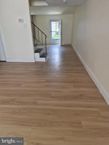 a view of an entryway with wooden floor