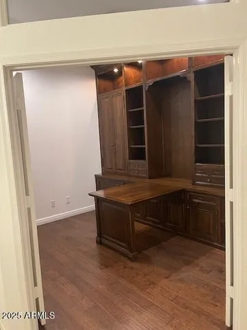 an empty room with wooden floor and closet