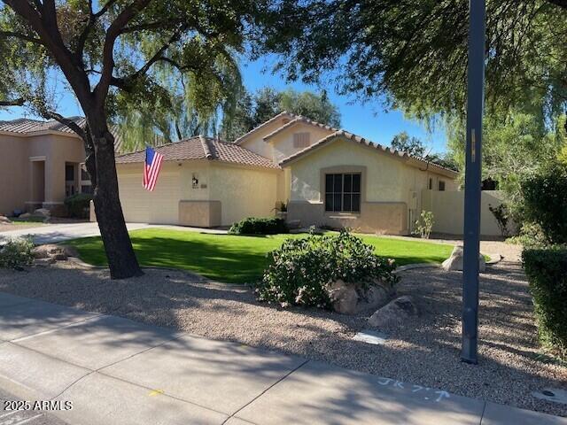 1038 South Roca Street Gilbert, AZ 85296 - Photo 2 of 47 a front view of a house with garden