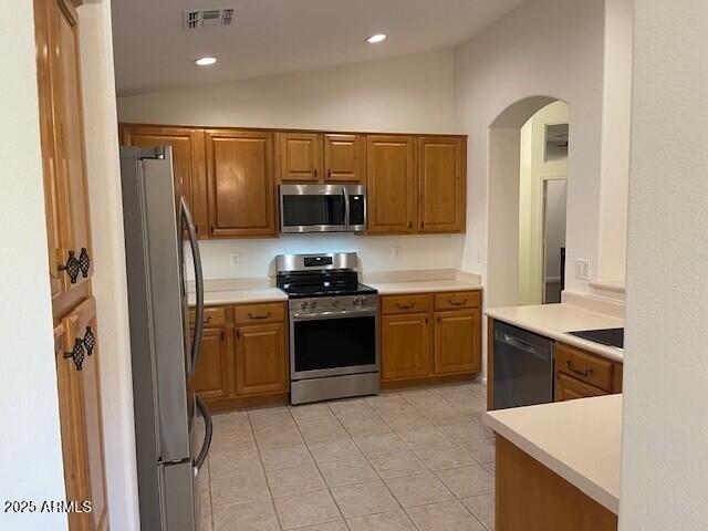 1038 South Roca Street Gilbert, AZ 85296 - Photo 23 of 47 a kitchen with stainless steel appliances granite countertop a refrigerator sink and stove