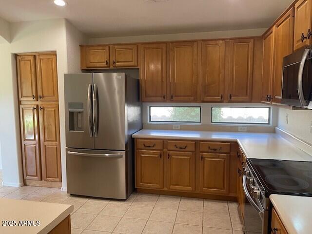 1038 South Roca Street Gilbert, AZ 85296 - Photo 24 of 47 a kitchen with a refrigerator and a sink
