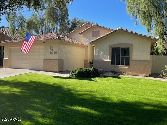 1038 South Roca Street Gilbert, AZ 85296 - Photo 3 of 47 a front view of a house with garden