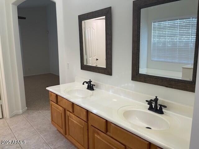 1038 South Roca Street Gilbert, AZ 85296 - Photo 32 of 47 a bathroom with 2 sink and a mirror