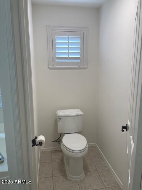 1038 South Roca Street Gilbert, AZ 85296 - Photo 33 of 47 a white toilet sitting next to a bathroom sink