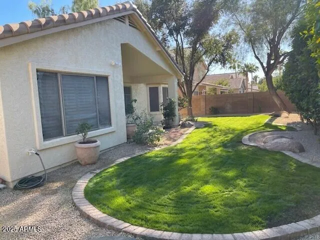 a backyard of a house with yard and outdoor seating