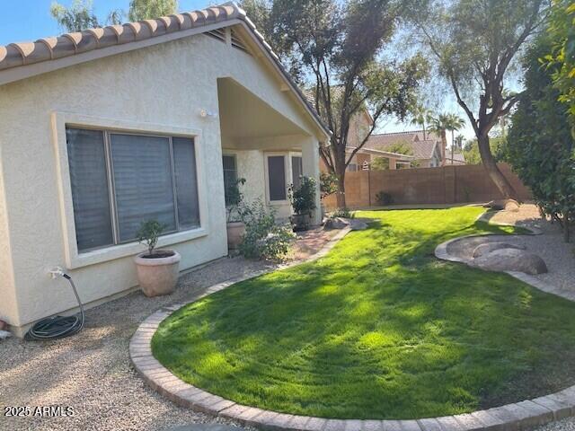 1038 South Roca Street Gilbert, AZ 85296 - Photo 7 of 47 a backyard of a house with yard and outdoor seating