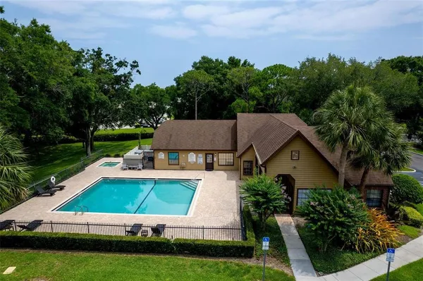 a aerial view of a house with swimming pool and a yard