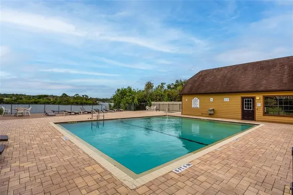 a view of a swimming pool with lounge chair