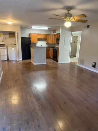 a view of a kitchen with a sink and refrigerator