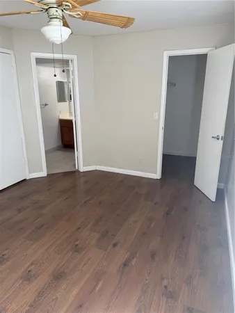an empty room with wooden floor and entryway
