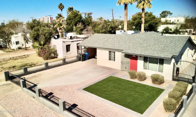 a view of a house with yard and sitting area