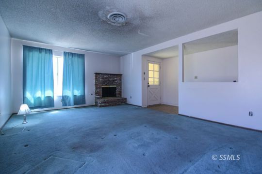537 South Fairview Street Ridgecrest, CA 93555 - Photo 5 of 35 an empty room with windows and fireplace