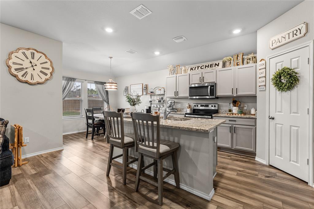 7121 Guadalupe Road Waco, TX 76633 - Photo 12 of 38 a kitchen with stainless steel appliances a table chairs and a refrigerator