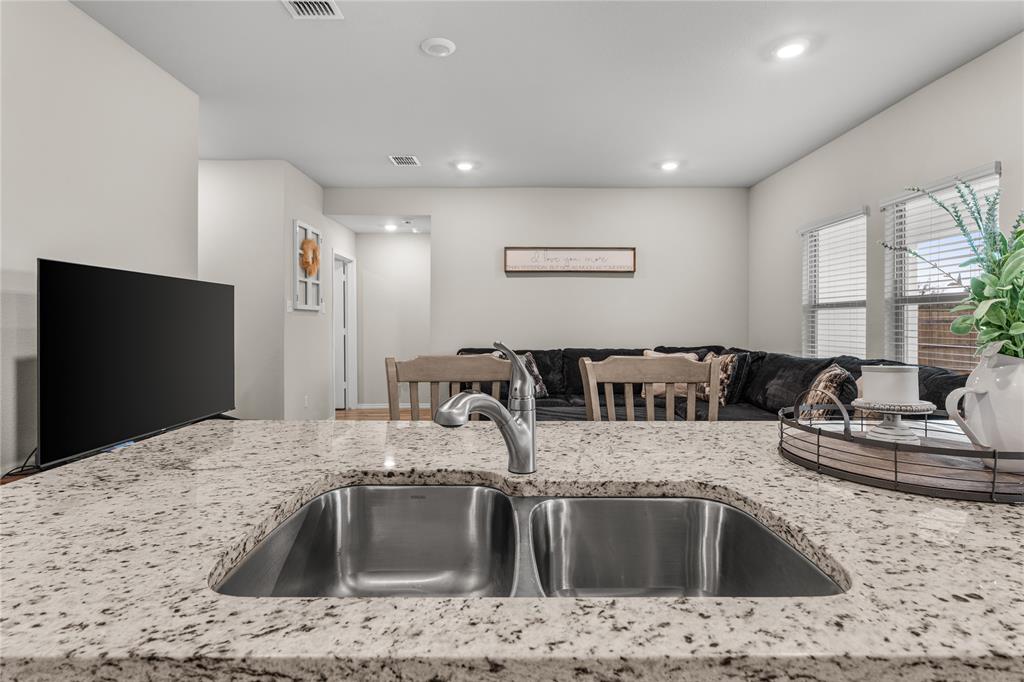 7121 Guadalupe Road Waco, TX 76633 - Photo 15 of 38 a kitchen with kitchen island a sink and a refrigerator