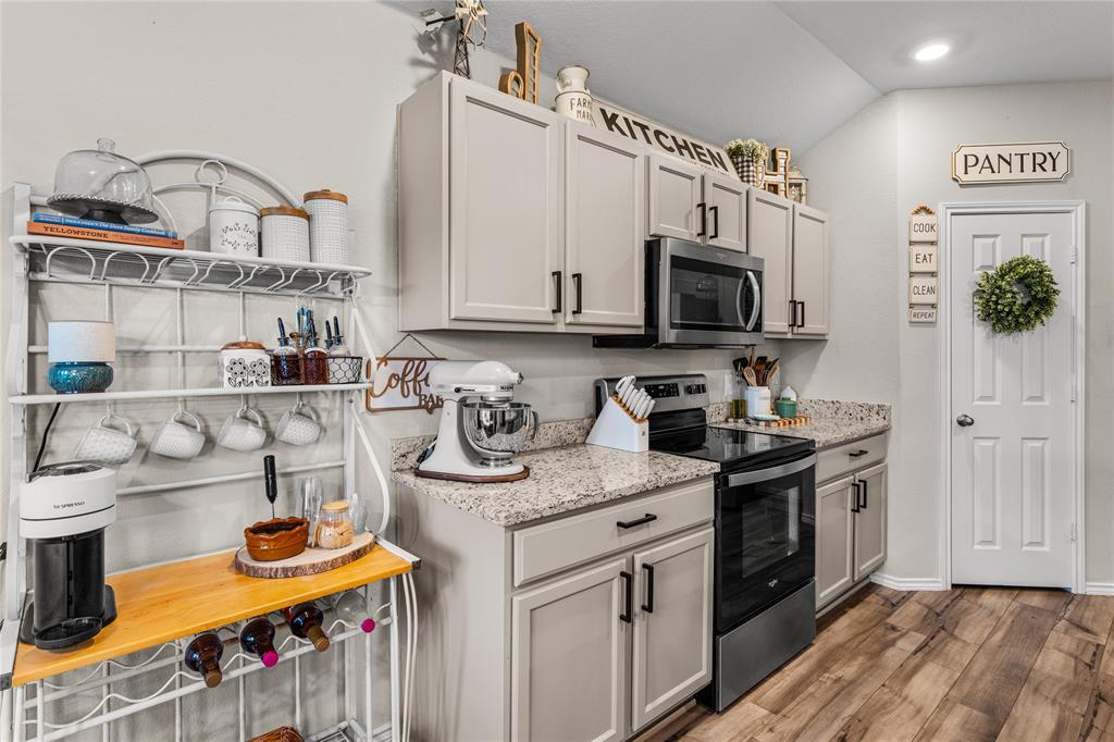 7121 Guadalupe Road Waco, TX 76633 - Photo 17 of 38 a kitchen with stainless steel appliances granite countertop a sink stove and cabinets