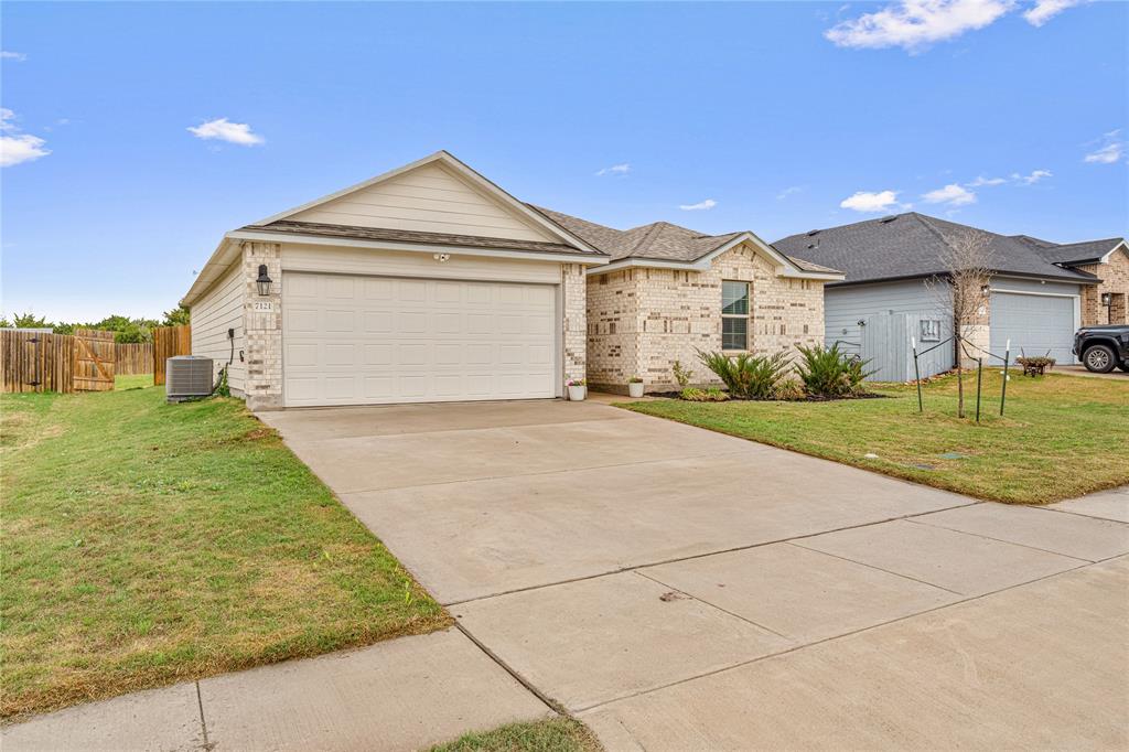 7121 Guadalupe Road Waco, TX 76633 - Photo 2 of 38 a front view of a house with a yard and garage