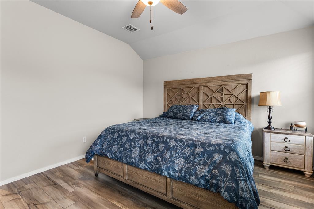 7121 Guadalupe Road Waco, TX 76633 - Photo 21 of 38 a bedroom with a bed and a chandelier