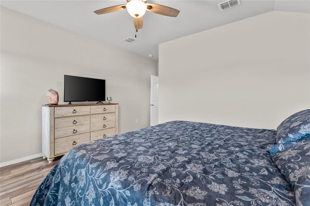 7121 Guadalupe Road Waco, TX 76633 - Photo 22 of 38 a bedroom with a bed and a flat screen tv