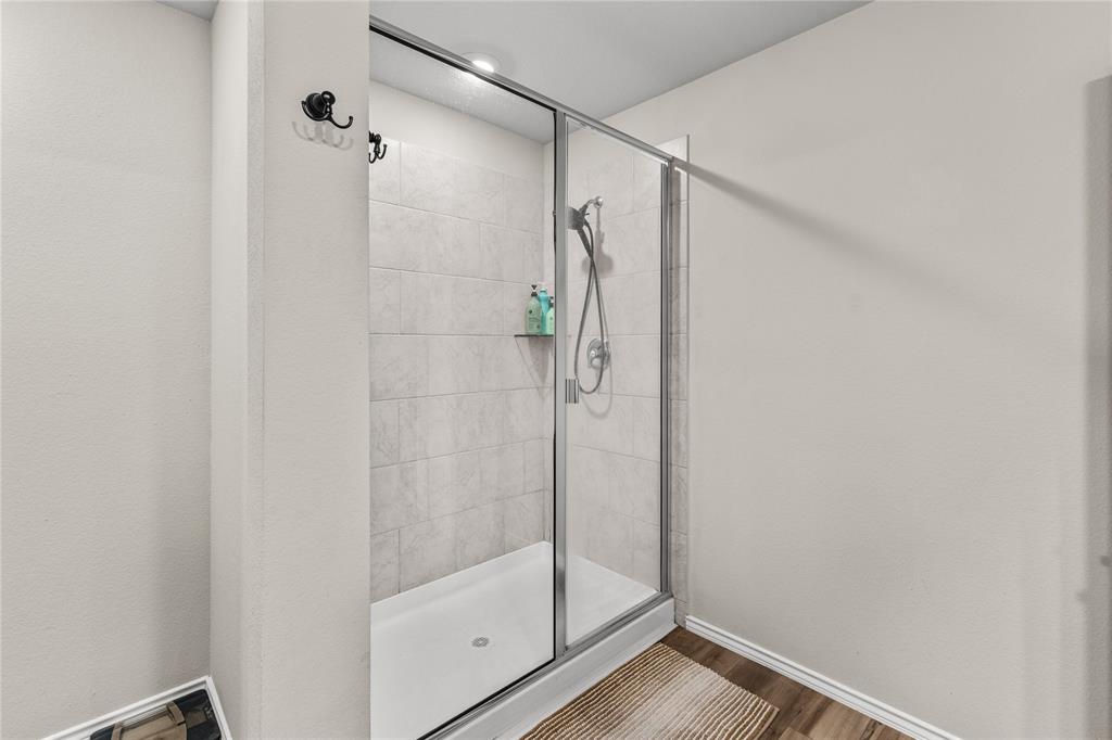 7121 Guadalupe Road Waco, TX 76633 - Photo 24 of 38 a bathroom with a glass shower door
