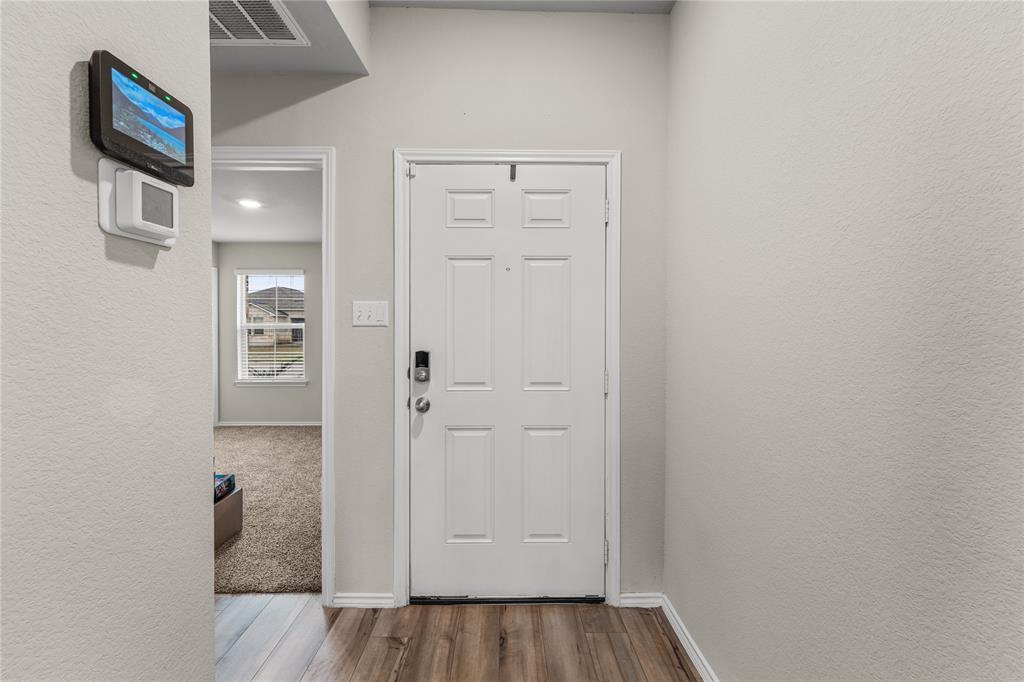 7121 Guadalupe Road Waco, TX 76633 - Photo 5 of 38 a view of a hallway with wooden floor and closet