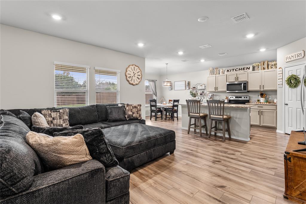 7121 Guadalupe Road Waco, TX 76633 - Photo 7 of 38 a living room kitchen with a table and chairs in it