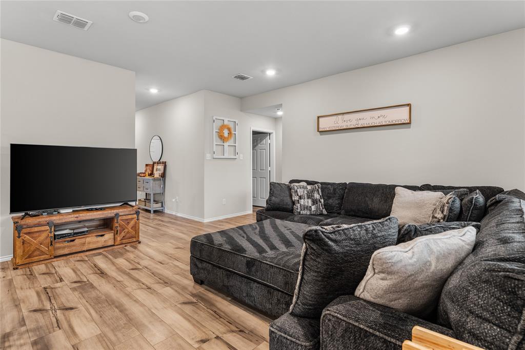 7121 Guadalupe Road Waco, TX 76633 - Photo 9 of 38 a living room with furniture and a flat screen tv