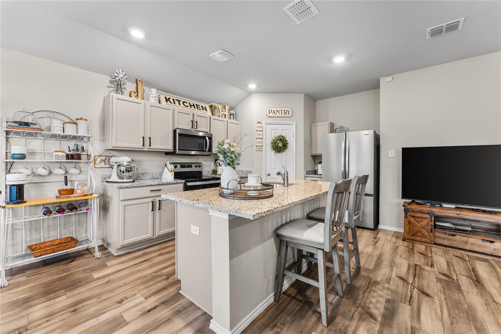 7121 Guadalupe Road Waco, TX 76633 - Photo 10 of 38 a kitchen with stainless steel appliances a stove a sink a refrigerator and a refrigerator