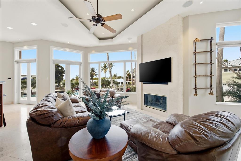 761 Norton Street Longboat Key, FL 34228 - Photo 16 of 66 a living room with furniture a fireplace and a flat screen tv