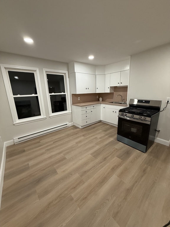 78 Forest Street, Unit 2 Attleboro, MA 02703 - Photo 5 of 7 a kitchen with stainless steel appliances kitchen island granite countertop a stove a sink and a refrigerator