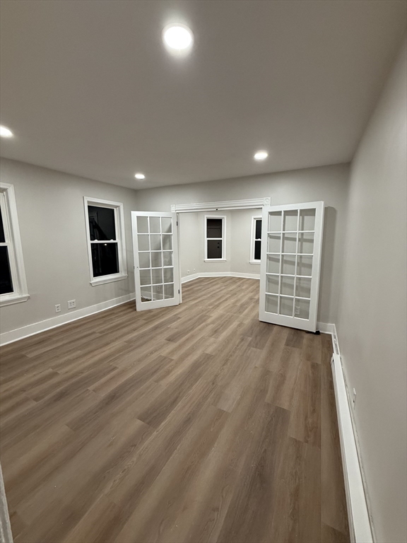 78 Forest Street, Unit 2 Attleboro, MA 02703 - Photo 7 of 7 an empty room with wooden floor and windows