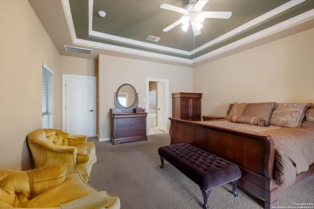 a spacious bedroom with two beds and a chandelier