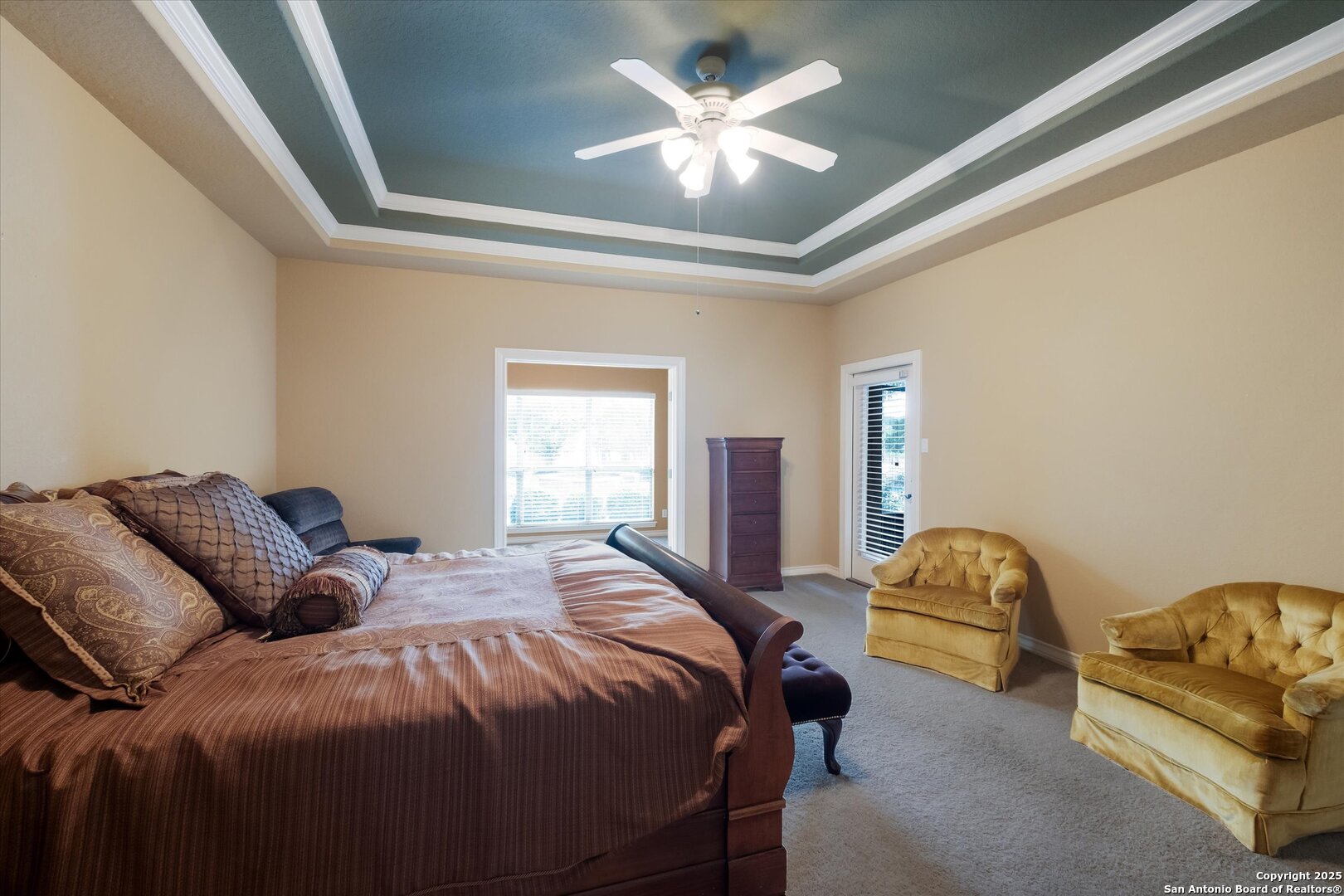 611 Ridge San Antonio, TX 78258 - Photo 20 of 42 a spacious bedroom with two beds and a chandelier