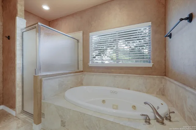 a view of an empty room with a window and kitchen view