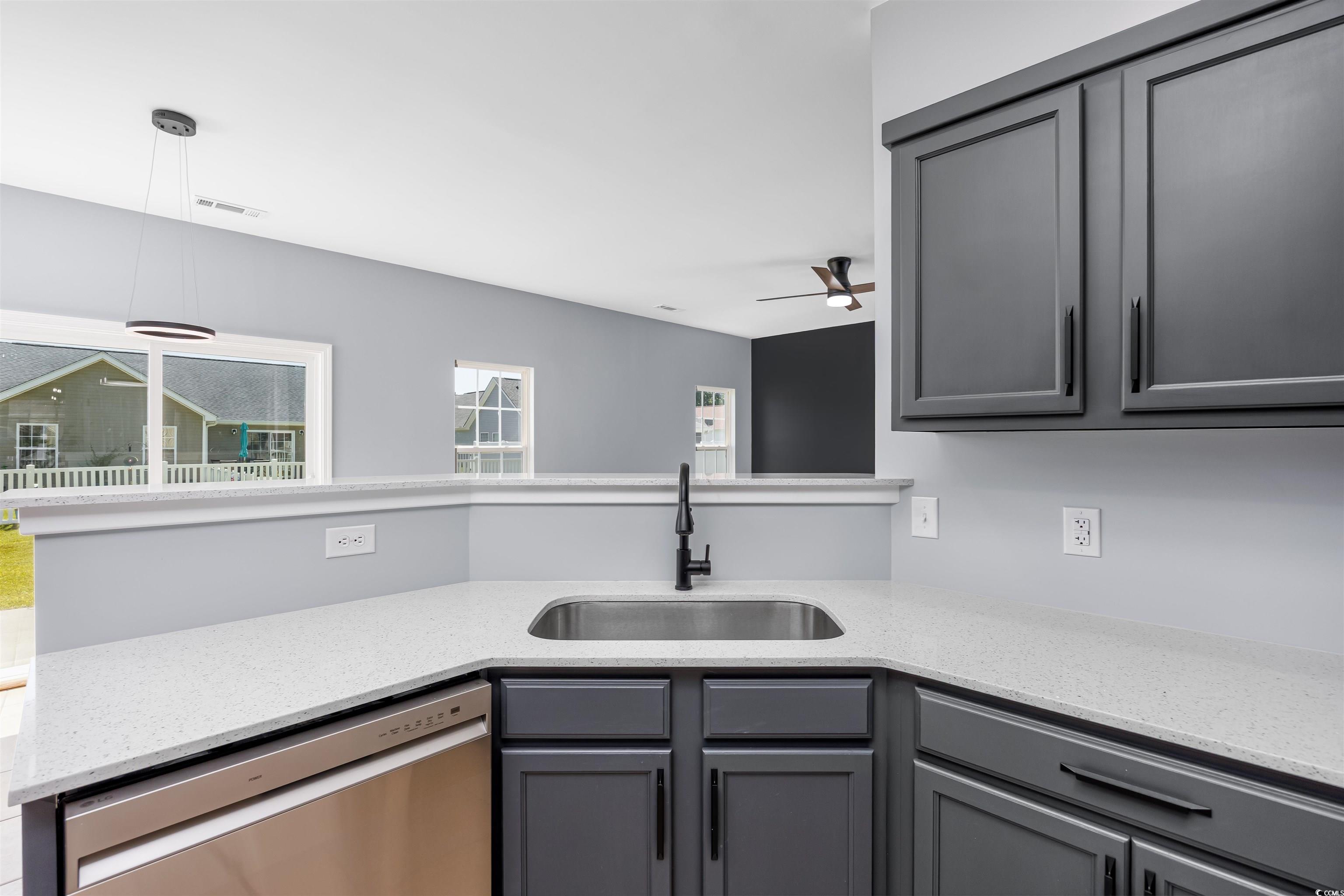 1031 Snowberry Drive Longs, SC 29568 - Photo 10 of 38 Kitchen featuring gray cabinets, light stone countertops, stainless steel dishwasher, hanging light fixtures, and a ceiling fan