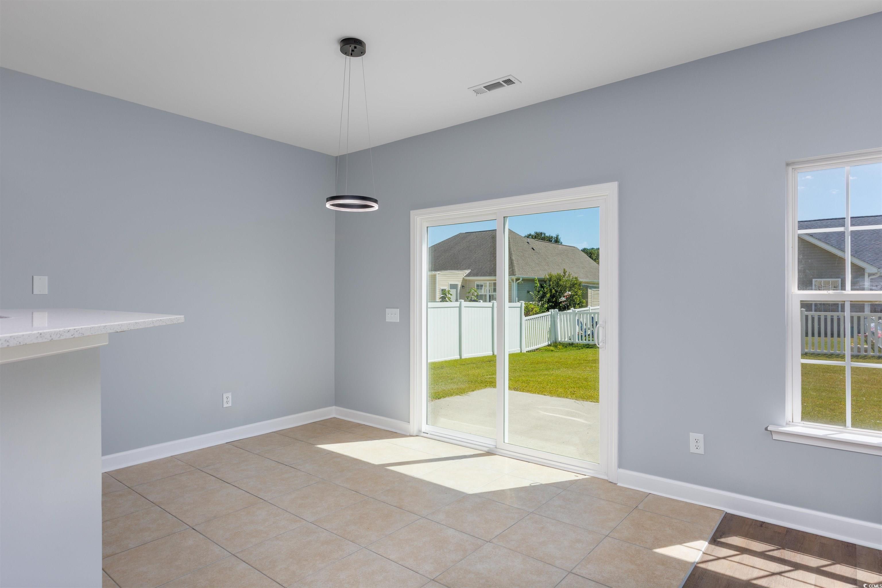 1031 Snowberry Drive Longs, SC 29568 - Photo 13 of 38 Unfurnished dining area with baseboards and light tile patterned floors