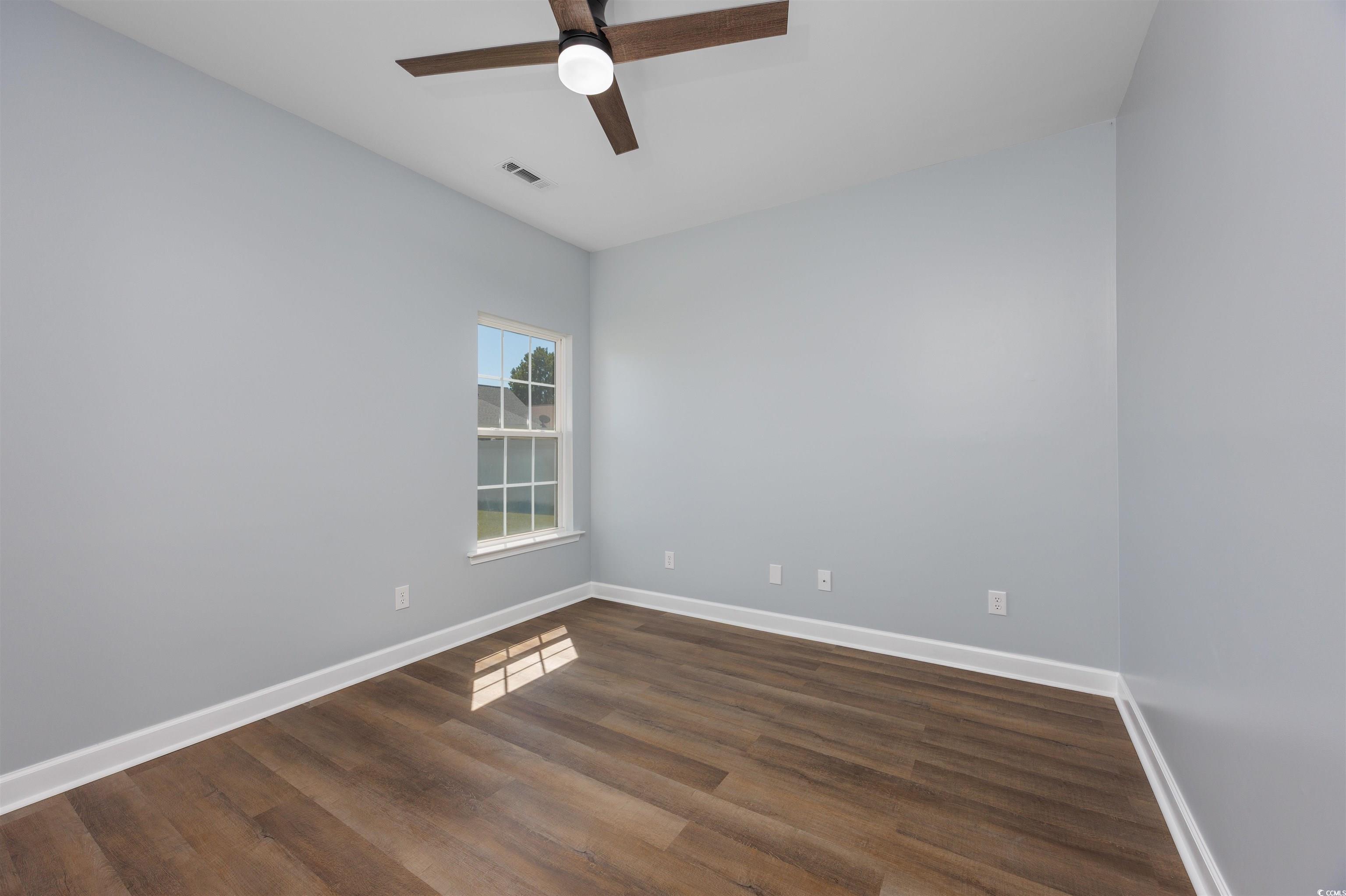 1031 Snowberry Drive Longs, SC 29568 - Photo 18 of 38 Spare room featuring dark wood finished floors and a ceiling fan