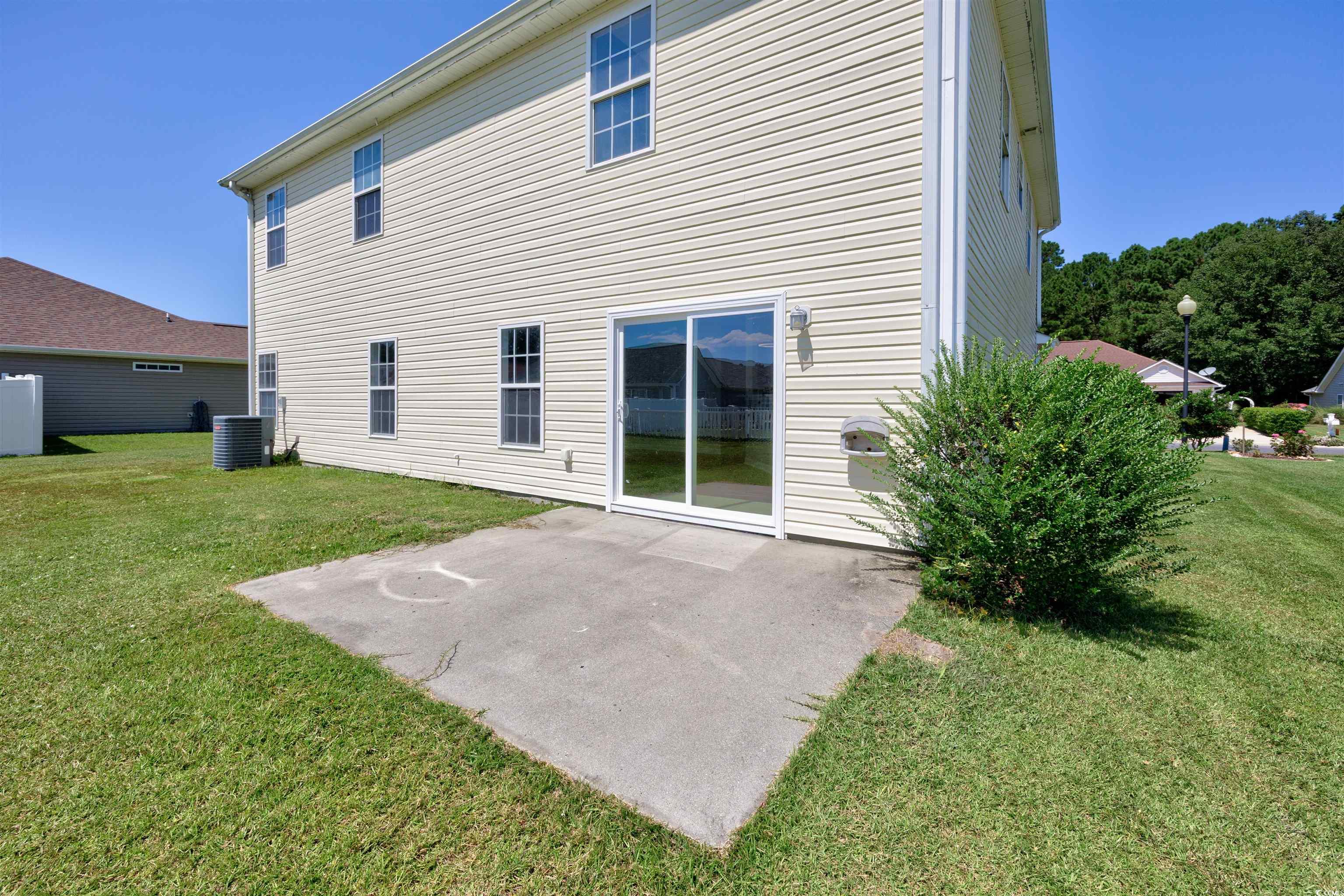 1031 Snowberry Drive Longs, SC 29568 - Photo 2 of 38 Rear view of house with a yard and a patio