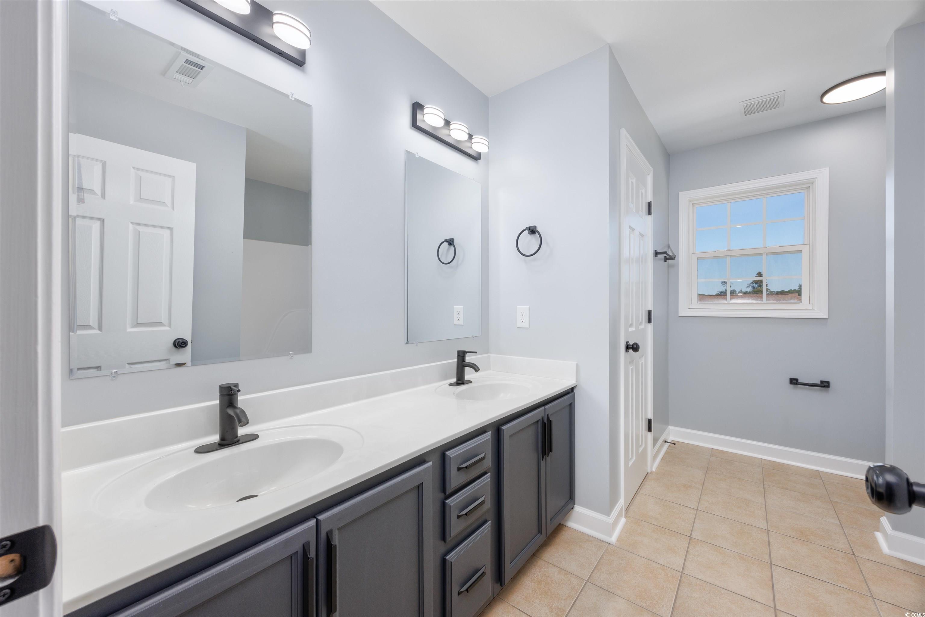 1031 Snowberry Drive Longs, SC 29568 - Photo 21 of 38 Bathroom featuring double vanity and light tile patterned floors