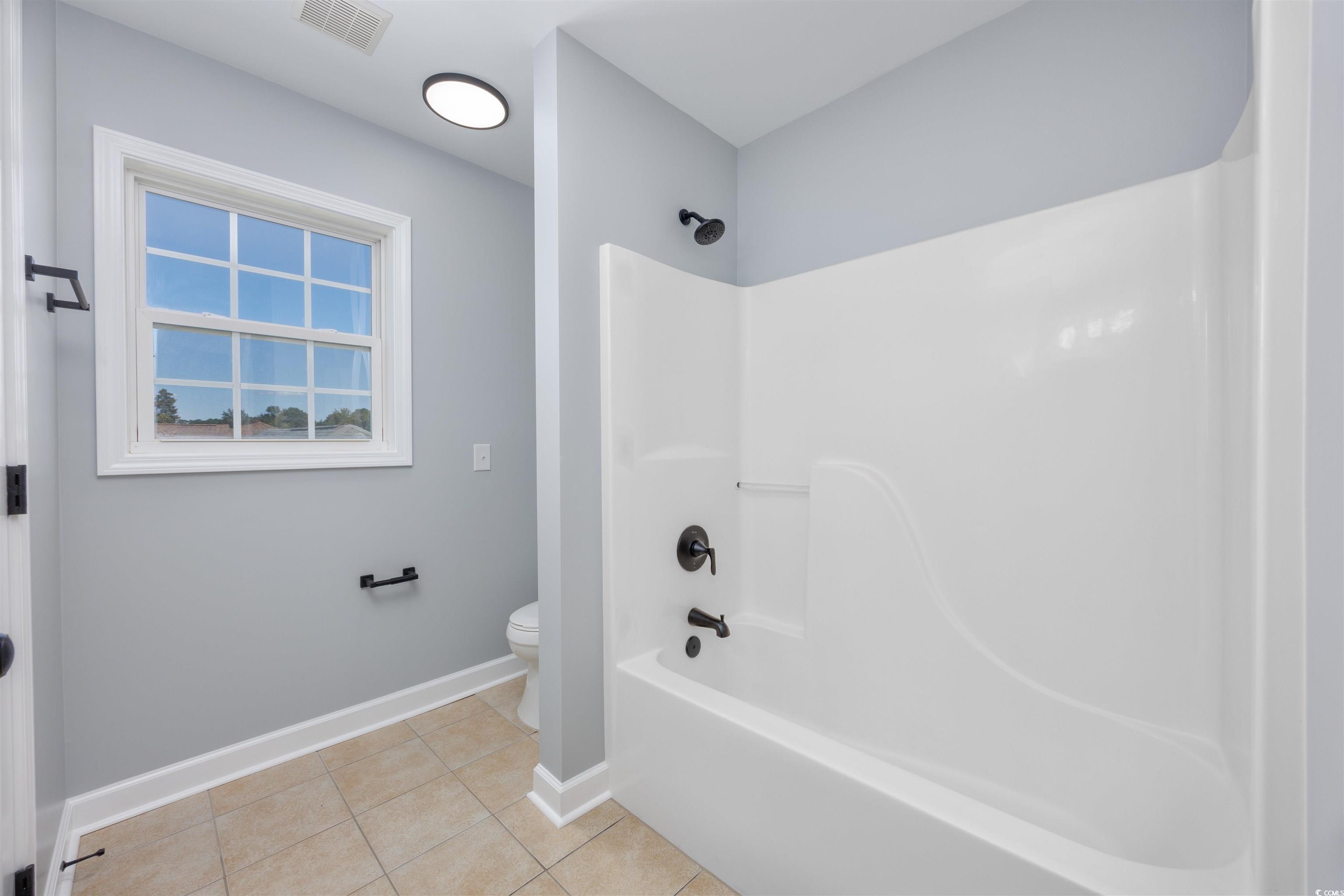 1031 Snowberry Drive Longs, SC 29568 - Photo 30 of 38 Full bathroom featuring shower / tub combination and tile patterned flooring