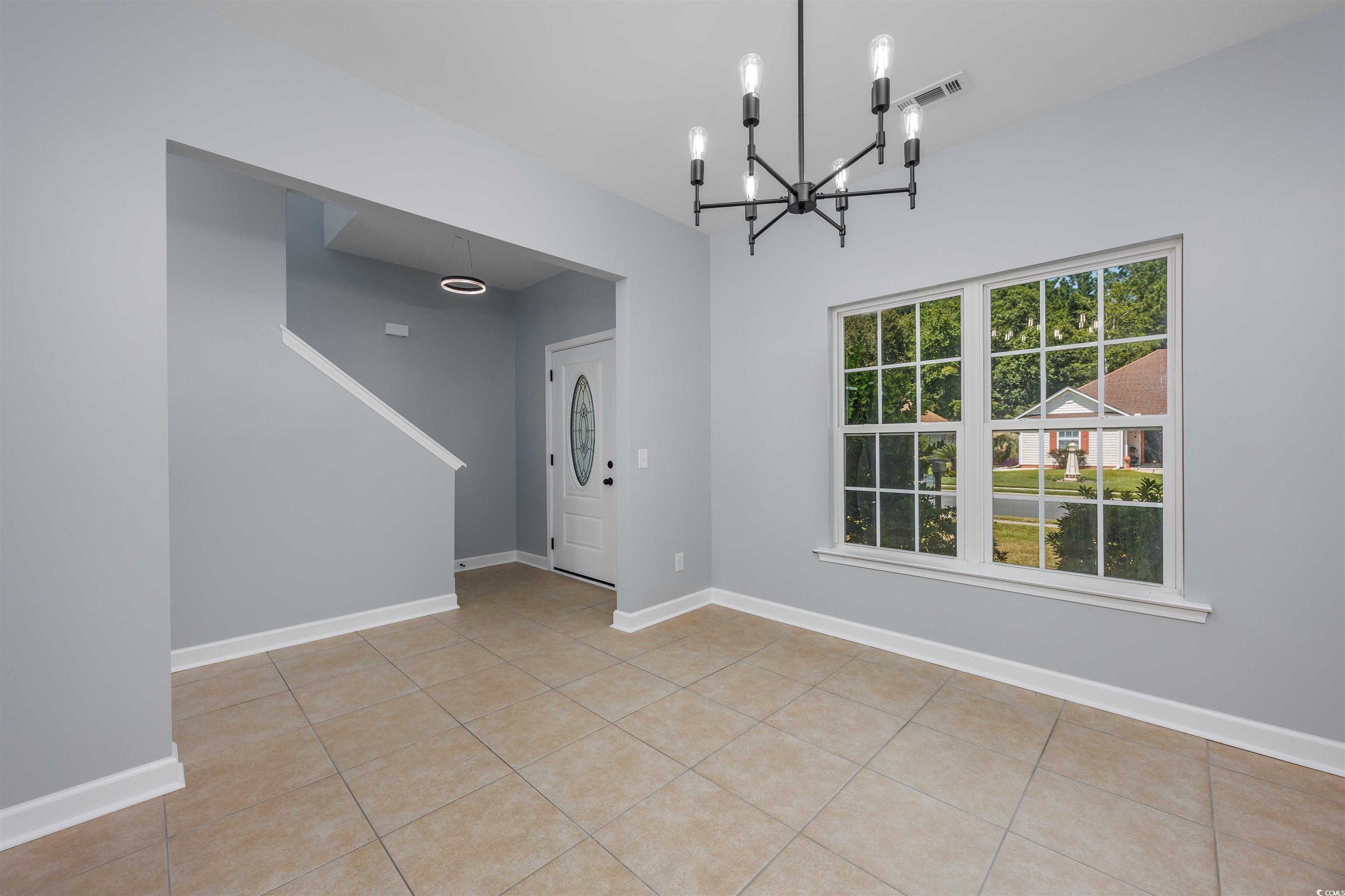 1031 Snowberry Drive Longs, SC 29568 - Photo 6 of 38 Unfurnished dining area with light tile patterned floors and a chandelier